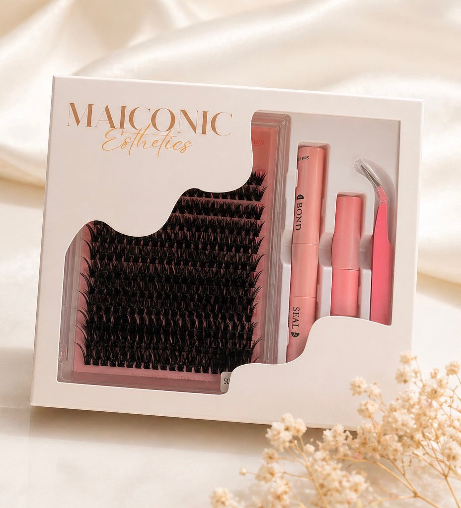 Eyelash extension set with tools in a Maiconic box on a light background